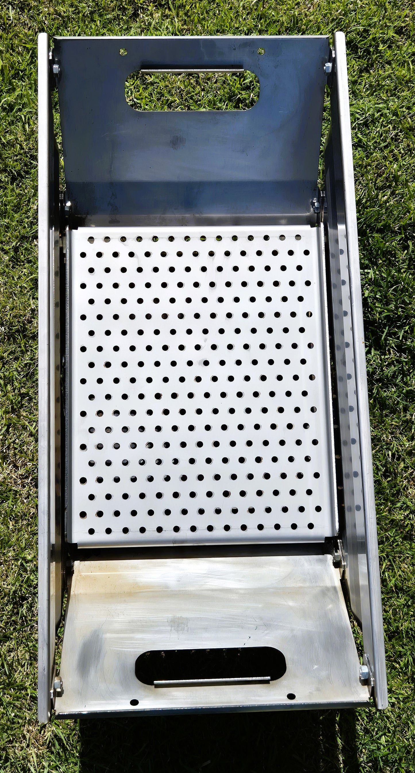 Metal grill with perforated design for charcoal grilling