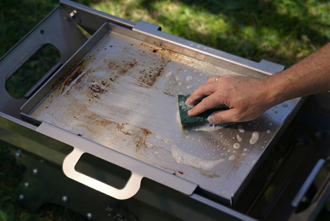 Clean stainless steel grill plate and hot plate stored with the Tyre Fire fire pit — ready for storage or travel.