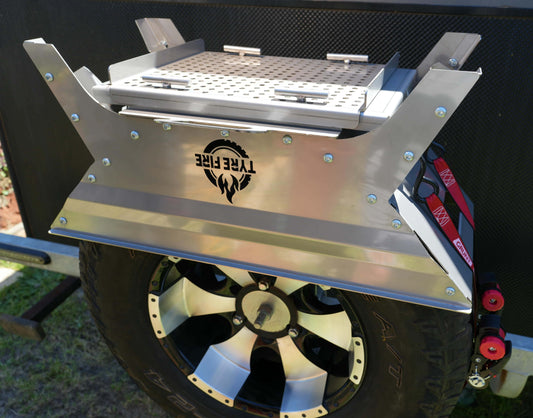 Tyre Fire patented caravan fire pit mounted on spare tyre showing integrated hot plate and grill plate storage.