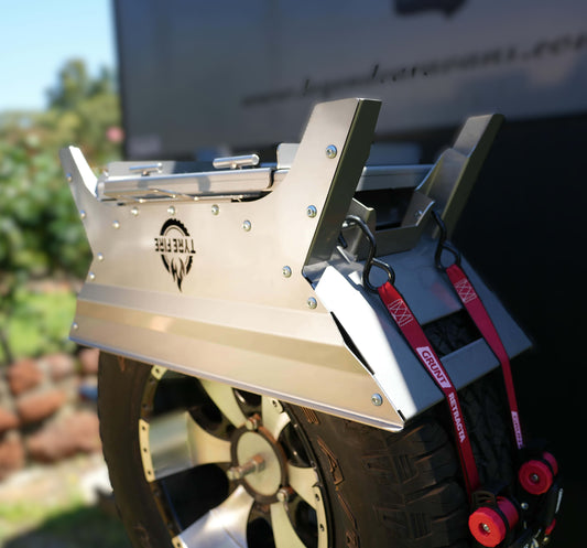 Tyre Fire stainless steel fire pit strapped to a spare tyre using AS/NZS 4380 compliant ratchet straps in a cross-over pattern.