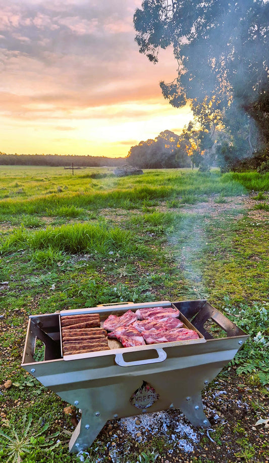 Tyre Fire portable stainless steel caravan fire pit cooking meat on grill plate in Australia..