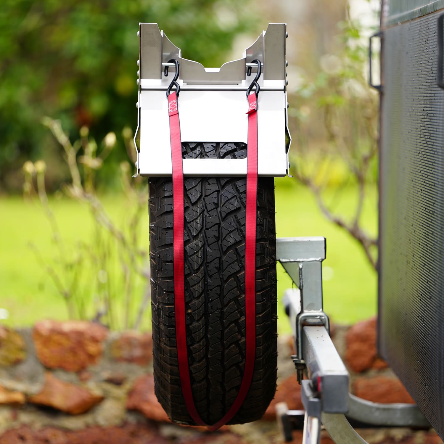 Tyre Fire Pit  with red straps attaching it to a spare tyre