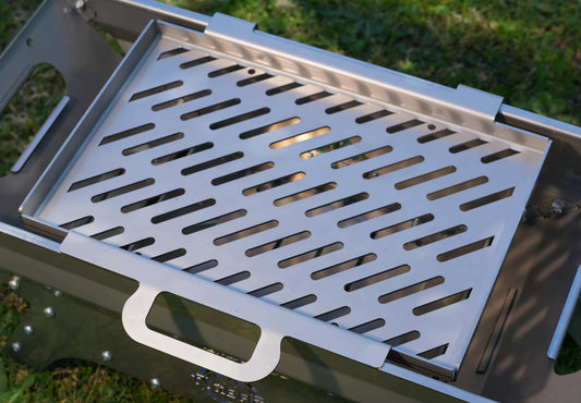 Caravan barbeque with stainless steel grill plate sitting on top ready for cooking