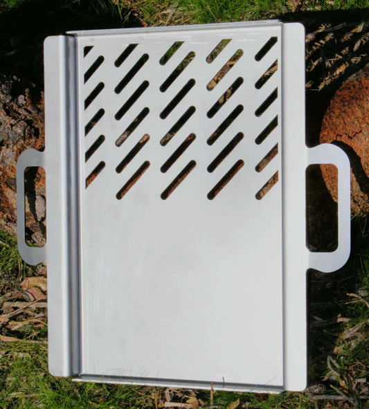 Stainless steel grill plate hot plate with handles on a natural background