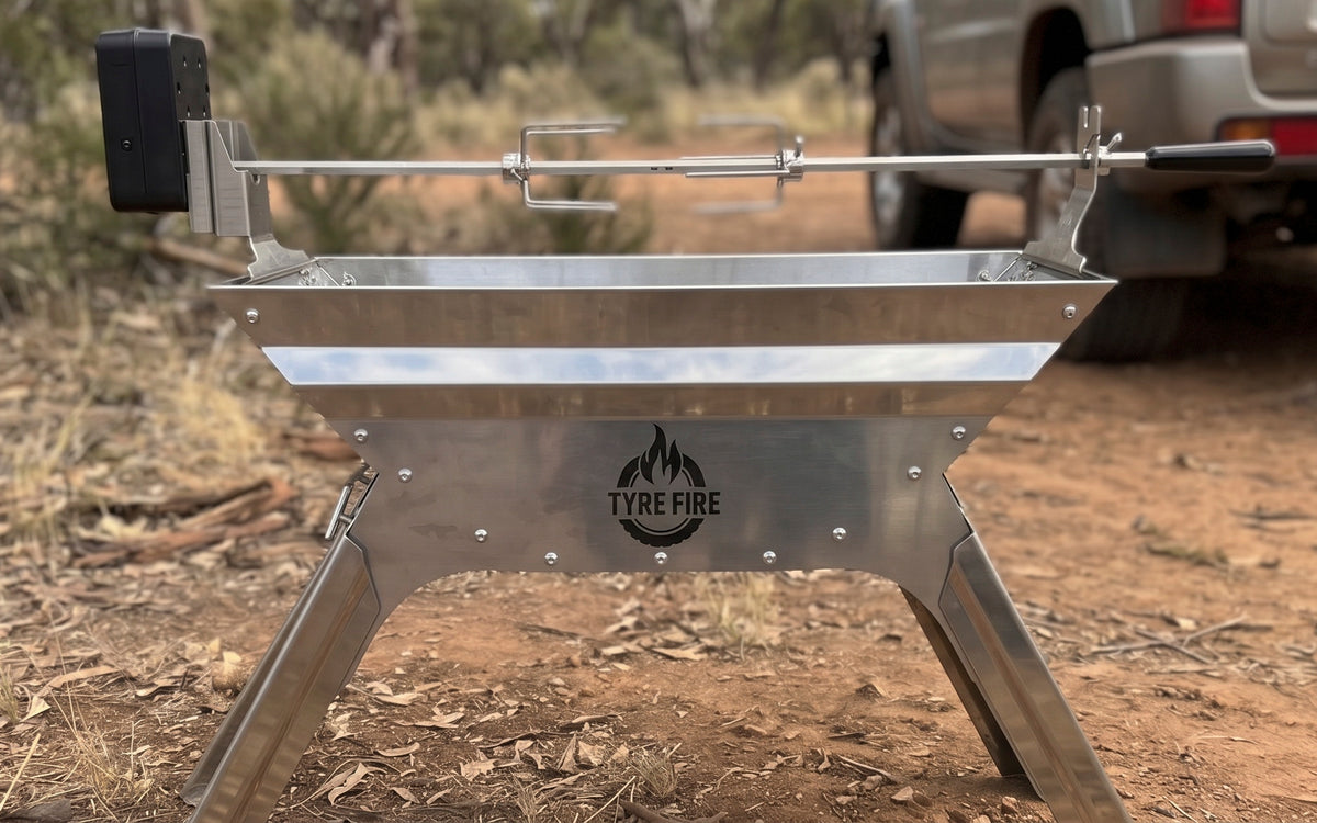 Tyre Fire rotisserie mounting kit fitted to a stainless spare tyre fire pit at a 4WD campsite