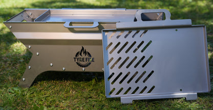 Precision-engineered Tyre Fire® portable fire pit with 2-in-1 BBQ grill plate showing the modular M8 bolted anti-warp chassis