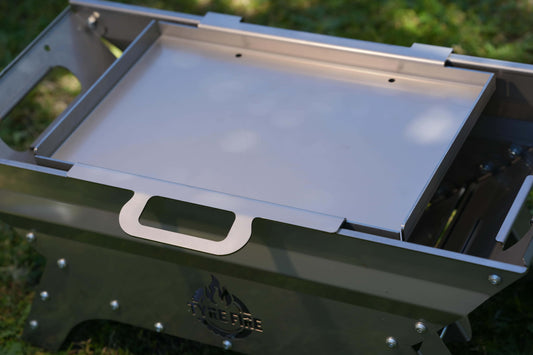 Stainless steel hot plate sitting on top of the Tyre Fire caravan barbeque / fire pit