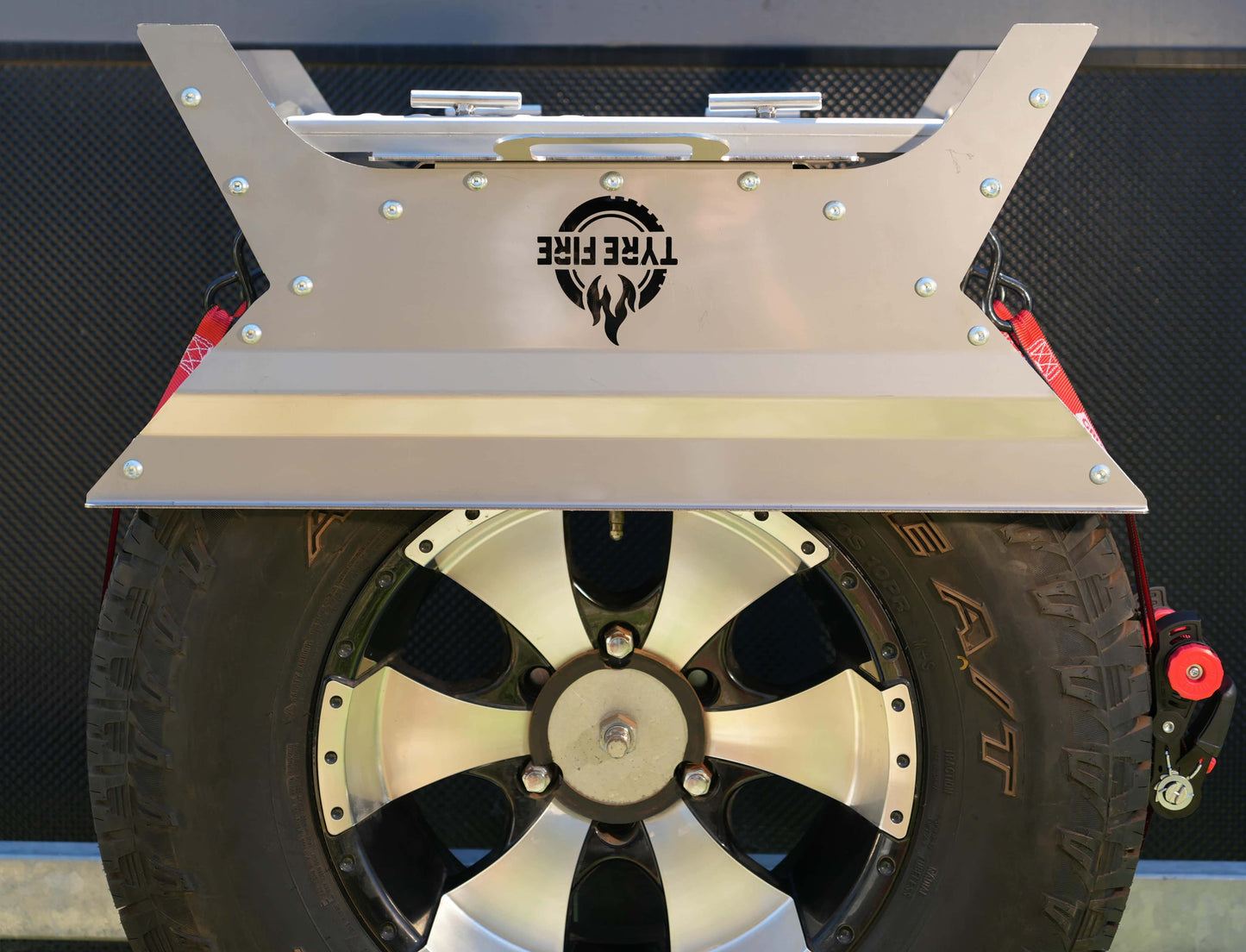 The Original Tyre Fire® mounted on a 4WD spare tyre featuring the integrated BBQ plate stored upside down to protect the cooking surface
